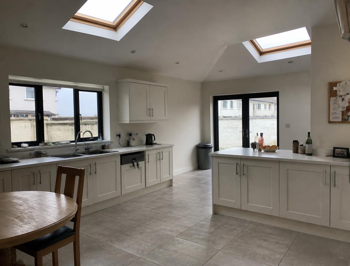 Bright kitchen extension interior with vaulted ceiling and rooflights